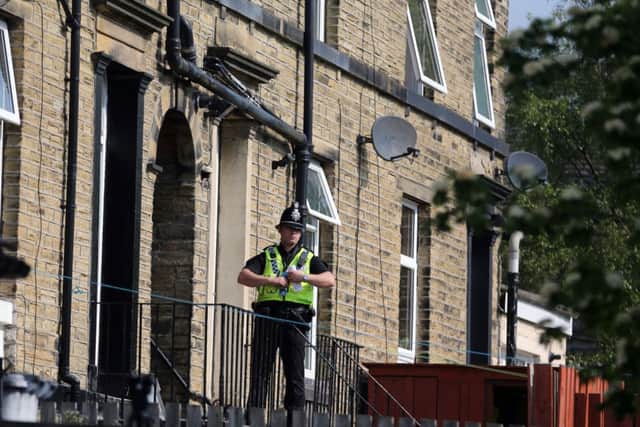 Police outside the house on Reinwood Road, Huddersfield. Picture: Ross Parry Agency