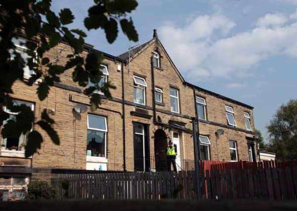 Police outside the house on Reinwood Road, Huddersfield. Picture: Ross Parry Agency