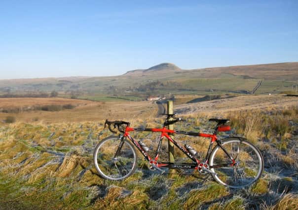 Drighlington Bicycle Club members David and Jane Todd's tandem with Pen-y-ghent in the background. Picture by David Todd