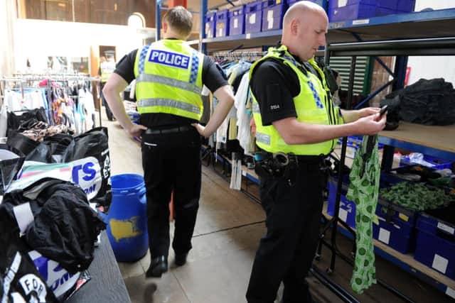 Police officers  during a raid by the Medicines Regulation Agency at a warehouse in Keighley.  Pictures by Bruce Rollinson