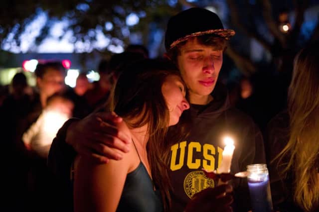 Two students comfort each other during a candlelight vigil held to honour the victims (AP Photo/Jae C. Hong)