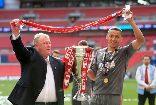 Rotherham United manager Steve Evans, left, celebrates with James Tavernier.