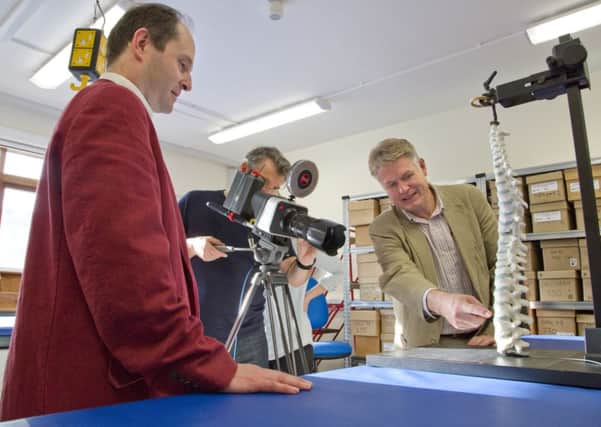 Gary Johnstone filming Piers Mitchell and Bruno Morgan discussing the 3D model of Richard IIIs spine for an upcoming Channel 4 programme. Credit:  Leicester University