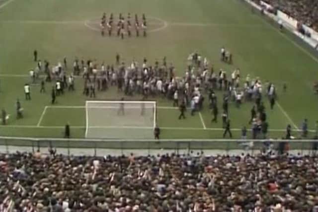 Video of Tottenham Hotspur fans spilling on to the perimeter track at the Leppings Lane end of the Hillsborough ground and others climbed fences shortly after the start of the 1981 FA Cup semi-final against Wolverhampton Wanderers