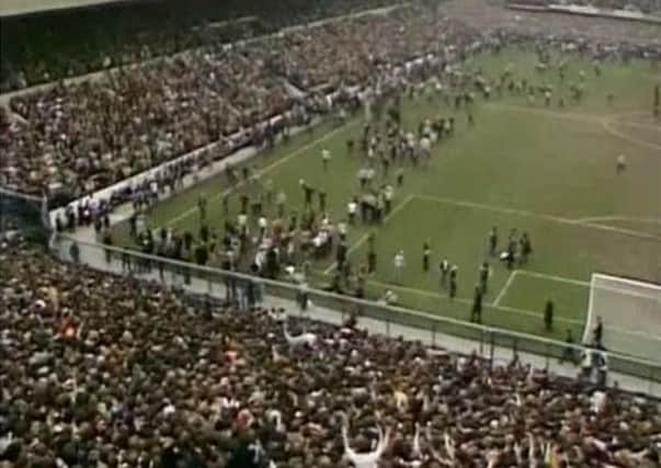 Video of Tottenham Hotspur fans spilling on to the perimeter track at the Leppings Lane end of the Hillsborough ground and others climbed fences shortly after the start of the 1981 FA Cup semi-final against Wolverhampton Wanderers