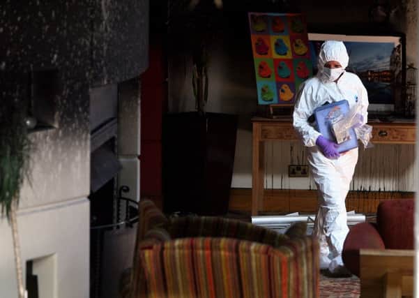 A police forensic expert in the reception area of the Everglades Hotel in the Prehen area of Derry-Londonderry