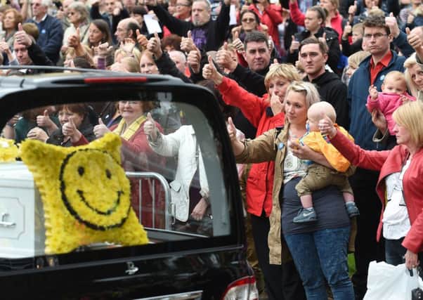 Onlookers give a thumbs up sign as the funeral cortege for Stephen Sutton makes it way from Lichfield Cathedral