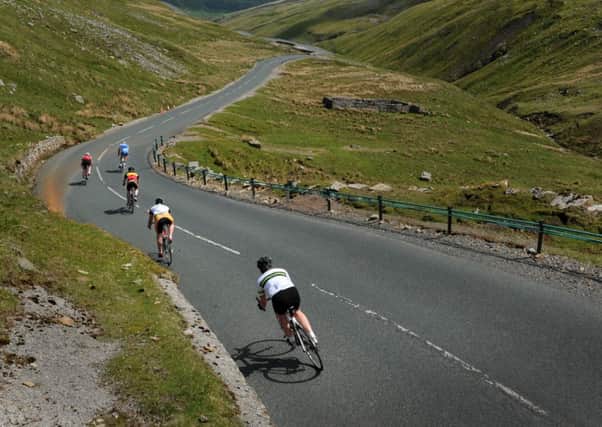 Cycol Rendezvous Tour guest riders descend off Buttertubs Pass during a preview of the first stage of the 2014 Tour de France. Picture by Bruce Rollinson