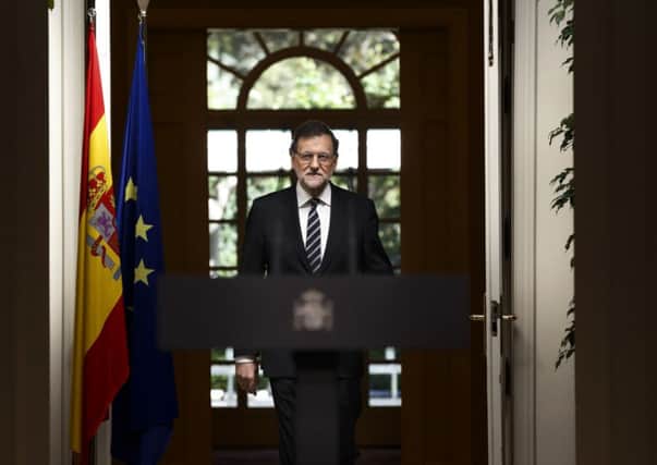 Spain's Prime Minister Mariano Rajoy enters the room to deliver a statement in the Moncloa Palace, Madrid