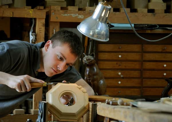 Andy Wadkins, an apprentice  worker,  carving the  mouse  on a barometer at Robert Thompson's in Kilburn