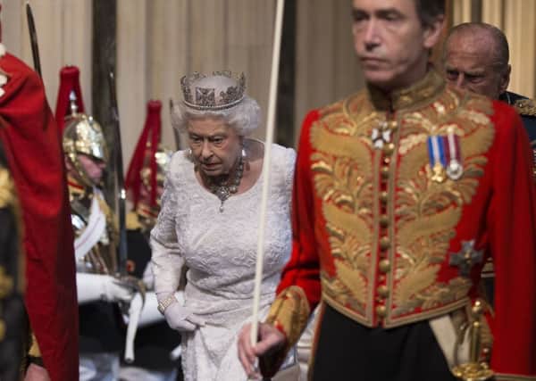 The Queen is escorted through the Norman Porch of the Palace of Westminster to attend the State Opening of Parliament
