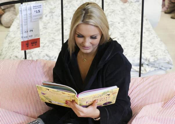 Reality TV star Sam Faiers reads a bedtime story as part of a 'Big Sleepover' event staged by Ikea