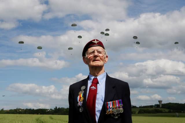 Normandy Veteran Fred Glover, 88, 9th Parachute Battalion, watches a parachute drop in Ranville, France, during a commemorative ceremony to mark the 70th anniversary of the D-Day landings during World War II.