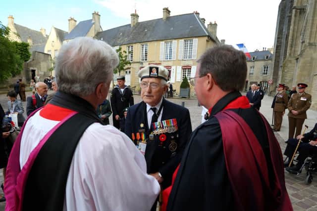 Normandy Veteran Tony Snelling, 91, talks to clergymen as he arrives at Bayeux Cathedral for a commemorative to mark 70th anniversary of the D-Day landings during World War II. PRESS ASSOCIATION Photo. Picture date: Friday June 6, 2014. See PA story MEMORIAL DDay. Photo credit should read: Gareth Fuller/PA Wire