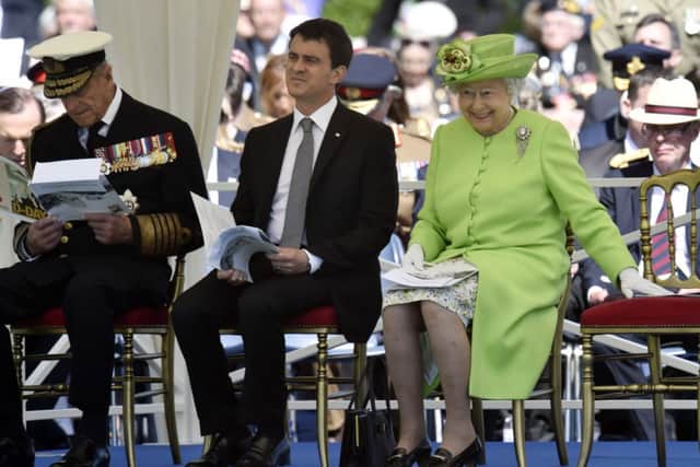 The Duke of Edinburgh, French Prime Minister Manuel Valls, and the Queen attend the Service of Remembrance at the Commonwealth War Graves Commission Cemetery, Bayeux