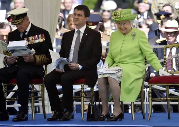 The Duke of Edinburgh, French Prime Minister Manuel Valls, and the Queen attend the Service of Remembrance at the Commonwealth War Graves Commission Cemetery, Bayeux