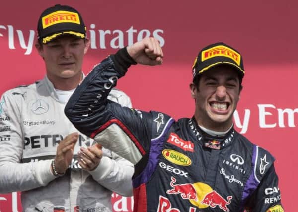 Red Bull driver Daniel Ricciardo from Australia celebrates his victory in the Canadian Grand Prix as second place Mercedes driver Nico Rosberg from Germany looks on.