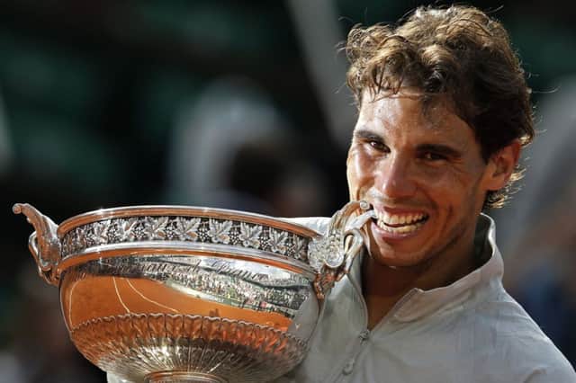 Spain's Rafael Nadal bites the trophy after winning the final of the French Open.