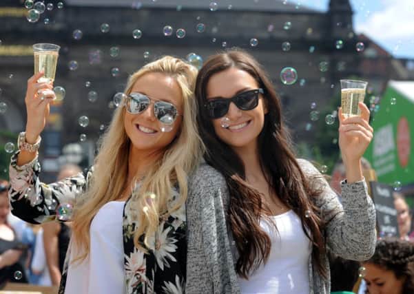 Sisters Laura (left) and Emily Powell, enjoy a glass of champagne on the Malmaison stand. PIC: Simon Hulme
