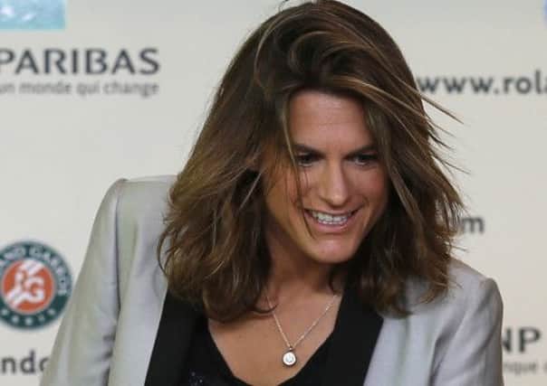 French tennis great Amelie Mauresmo arrives for a press conference at the Roland Garros stadium, in Paris, France, Sunday, June 8, 2014. Britain's Andy Murray has appointed Mauresmo as his coach Sunday.
