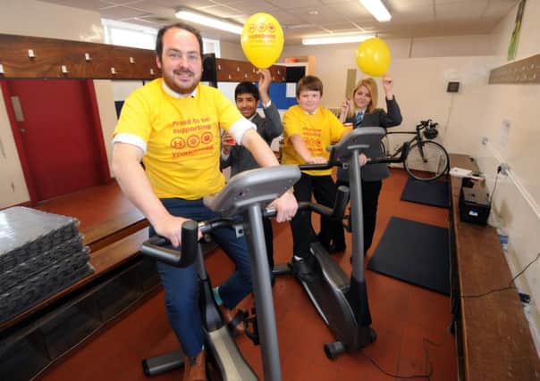 Teacher Matthew Burton, with pupils Akeel Azam, Harry Boulton and Eva Koczan at Thornhill Community Academy, in Dewsbury, preparing for Wear it Yellow Day on July 3. Picture by Simon Hulme