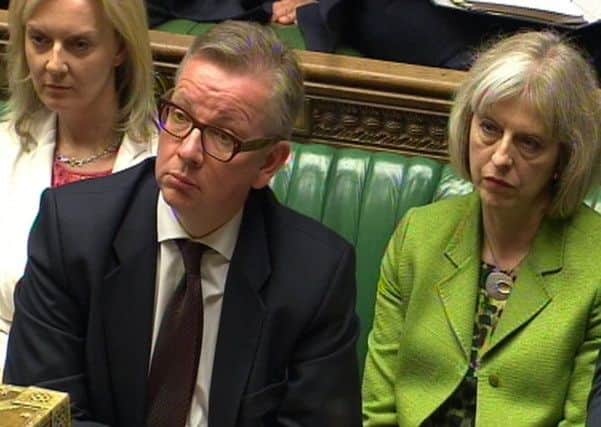 Education Secretary Michael Gove and Home Secretary Theresa May listen in the House of Commons, London, after Ofsted placed five Birmingham schools into special measures in the wake of the "Trojan Horse" allegations
