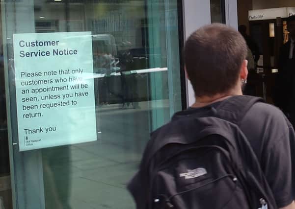 A sign in the Passport Office in central London as the Passport Office is to put more staff and resources in place to deal with a backlog of applications caused by a surge in people wanting to go abroad