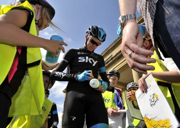 Team Sky's Chris Froome signs autographs for youngsters at a Harrogate Hotel