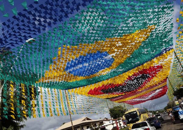 A street is decorated with national flags of countries near Santa Cruz Cabralia, Brazil