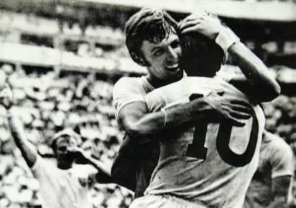 Geoff Hurst, is hugged by teammate Martin Peters, after he scored England's goal during the game against Rumania in the 1970 World Cup.