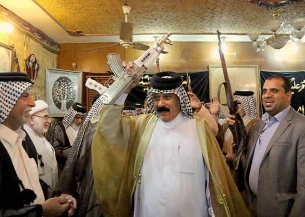 Iraqi Shiite tribal leaders chant slogans against the al-Qaida-inspired Islamic State of Iraq and the Levant (ISIL), in Baghdad,