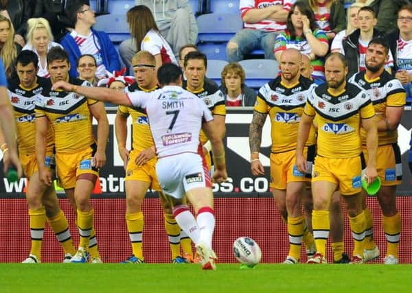 The Tigers watch Wigan Warriors' Matty Smith take another conversion.