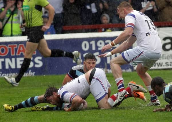 Danny Kirmond goes over for Wakefield's first try.
