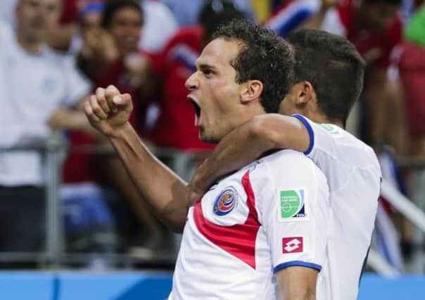 Costa Rica's Marco Urena, left, celebrates after scoring his side's third goal.