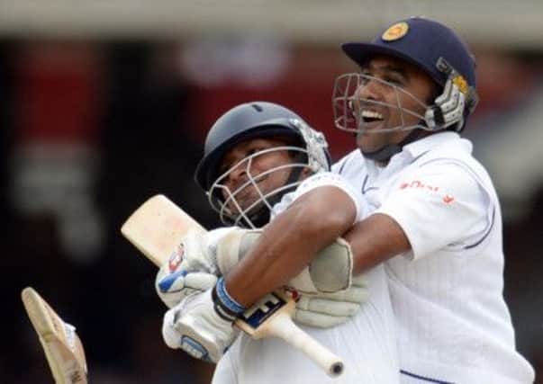 Sri Lanka's Kumar Sangakkara, left, is congratulated by Mahela Jayawardene after scoring his first century at Lord's.