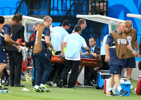 England physio Gary Lewin is carried off injured on a stretcher in Manaus.