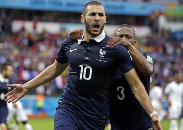 France's Karim Benzema celebrates his goal with team-mate Patrice Evra.
