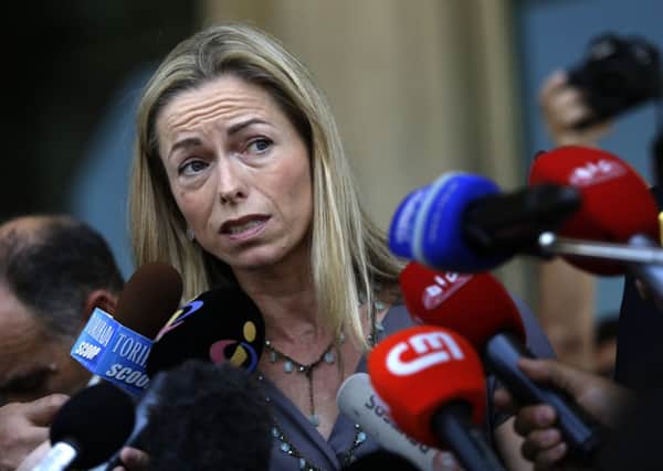Kate McCann talks to journalists as she leaves with her husband a court in Lisbon