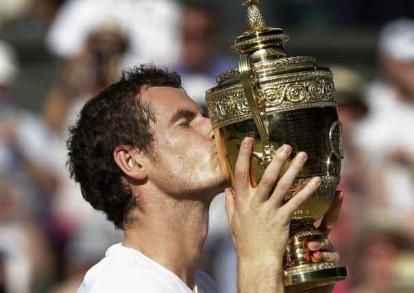Great Britain's Andy Murray kisses his trophy after defeating Serbia's Novak Djokovic in the Wimbledon Men's Final last year.