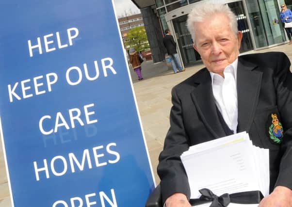 Albert Lemasurier of Doncaster hands over a petition protesting at the closure of care homes.