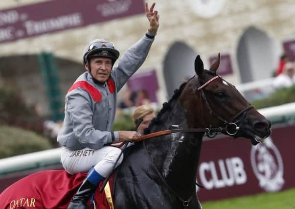 French jockey Thierry Jarnet gestures after winning the Qatar Prix de l'Arc de Triomphe aboard Treve (Picture: Francois Mori/AP).