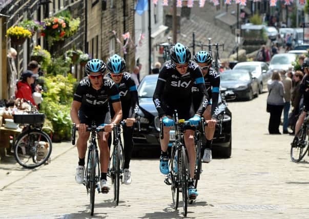 Chris Froome (front right) rides alongside Richie Porte  as the Sky riders climb the cobbled hill at Haworth. Picture by John Giles/PA Wire