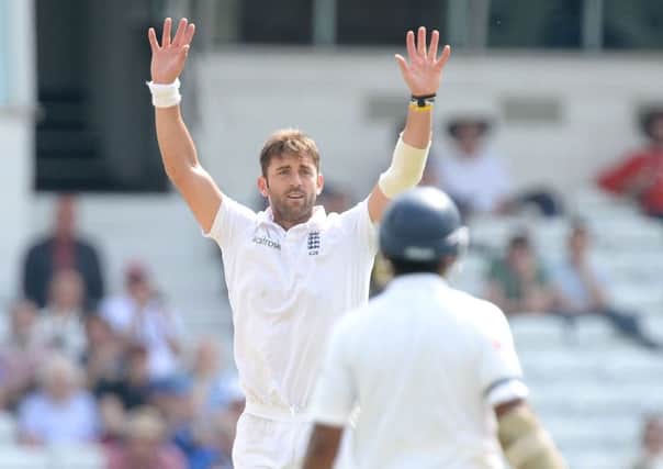 England's Liam Plunkett celebrates taking the wicket of Sri Lanka's Dimuth Karunaratne (not pictured) with Kumar Sangakkara (right), during day three of the second Investec Test match at Headingley, Leeds.