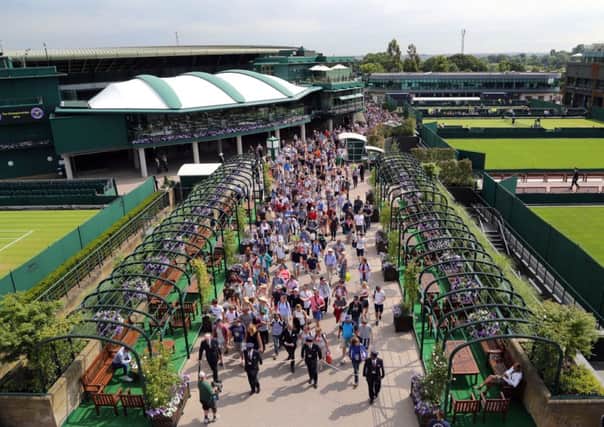 Crowds are led into the grounds ahead of day one of the Wimbledon Championships at the All England Lawn Tennis and Croquet Club, Wimbledon.