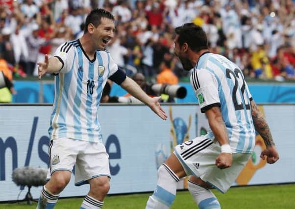 Argentina's Lionel Messi, left, celebrates with his teammate  Ezequiel Lavezzi after scoring his side's second goal  against Nigeria.