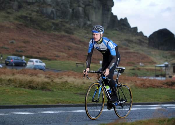 Scott Thwaites, from Burley in Wharfedale, rides past the Cow and Calf Rock above Ilkley. (Picture: Bruce Rollinson)