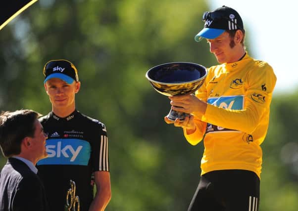 Great Britain's Bradley Wiggins of Sky Pro Racing (centre) stands on the winners podium in Paris, with team mate, Chris Froome (left) who came second in 2012.