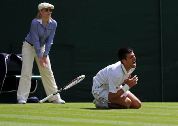 Serbia's Novak Djokovic falls heavily during his match against France's Gilles Simon.