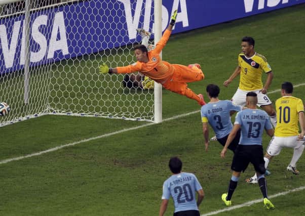 Colombia's James Rodriguez, right, scores his side's second goal past Uruguay's goalkeeper Fernando Muslera during the World Cup. (AP Photo/Themba Hadebe)