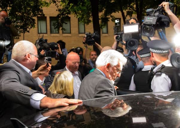 Rolf Harris leaves Southwark Crown Court after being found guilty of 12 sex charges involving four women.